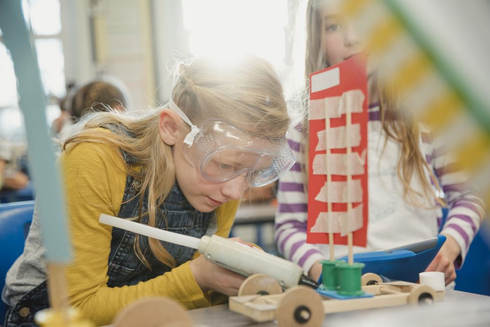 Elementary school children work together to build 3d models using recycled materials during class. This is a school in Hexham, Northumberland in north eastern England.